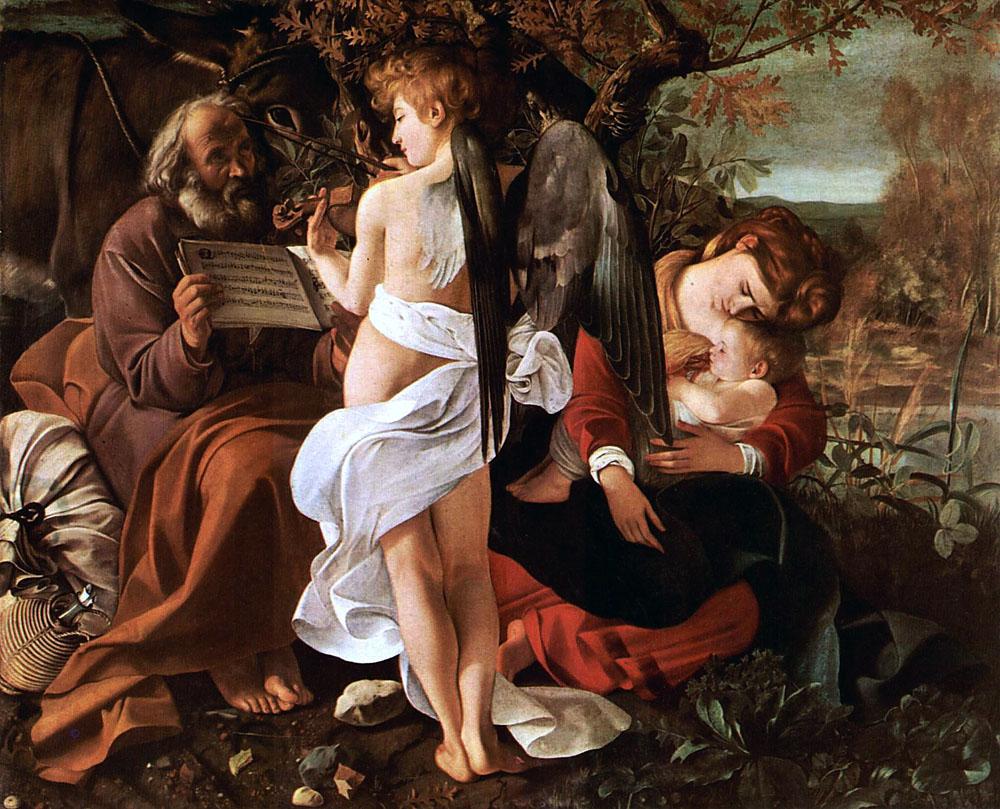 Michelangelo Merisi, il Caravaggio nacque nell’omonima cittadina della bassa bergamasca o, secondo alcuni, a Milano nel 1571. Artista dal temperamento inquieto, superò l’accademismo manierista inaugurando una nuova concezione estetica fondata su un accentuato naturalismo e che, nella fase più matura, raggiunse intensi e drammatici effetti luministici. Formatosi a Milano presso il pittore leonardesco Simone Peterzano, subì l’influsso della cultura lombardo-veneta di Lotto, Savoldo e Moroni, ma anche dell’opera cremonese dei Campi. Nel 1590 il pittore è a Roma, dove conobbe momenti di miseria e dove entra nella bottega del Cavalier d’Arpino. A questa prima  fase artistica appartiene il Riposo durante la fuga in Egitto così come varie opere “di genere” con scene di carattere popolare. in cui prevalgono un tono malinconico e colori luminosi ancora di derivazione veneta.  Ben diverso appare il tema Fuga in Egitto così come è trattato dal pennello di Caravaggio. Il Merisi nel suo dipinto, anch’esso alla Galleria Doria Pamphilj di Roma, pone al centro le figure umane e il paesaggio assume solo un ruolo di contorno e sottofondo, con la vegetazione caratterizzata da essenze comuni e prive di ogni esotismo. Maria, vinta dalla fatica del viaggio e dalle emozioni, si è addormentata tenendo teneramente  fra le sue braccia il Bambino, anch’esso dormiente. Giuseppe, da buon padre, veglia e la sua figura assume accenti di profonda umanità. Basterebbe guardare i suoi piedi, con l’uno che strofina l’altro intorpidito e infreddolito. Al suo fianco un sacco raccoglie le povere masserizie salvate nella fretta della fuga. Appare anche un piccolo e gustoso particolare: il fiasco impagliato di cui però Giuseppe ha dimenticato il tappo sostituendolo con pezzo di carta arrotolata. Tutto è molto umano e concreto, anche l’angelo, che col suo violino scende dai cieli ad allietare il sonno del Bambino, poggia solidamente i piedi per terra e legge lo spartito che Giuseppe tiene aperto di fronte a lui, proprio come farebbe un musicista qualsiasi (tra l’altro si tratta di un “mottetto” olandese trascritto con cura dal Merisi, ottimo conoscitore della notazione musicale). E solo ora l’osservatore si accorge che tra le foglie del querciuolo alle spalle di queste figure, si fa strada il muso dell’asinello che assiste nel viaggio la Sacra Famiglia e che appare anch’esso attratto dalla melodia celestiale. Se il dipinto di Caravaggio appare così calato nel reale, come spesso avviene nel pittore di origini bergamasche, la natura e il paesaggio svolgono anche un ruolo simbolico importante: accanto all'anziano Giuseppe il terreno appare arido e sassoso, mentre la natura ed il paesaggio sono più rigogliosi a destra, dove si trova la Vergine col Bambino. Ai piedi della Vergine stanno poi piante che simbolicamente alludono alla verginità di Maria (l'alloro), alla Passione (la rosa), alla Resurrezione (il tasso barbasso).